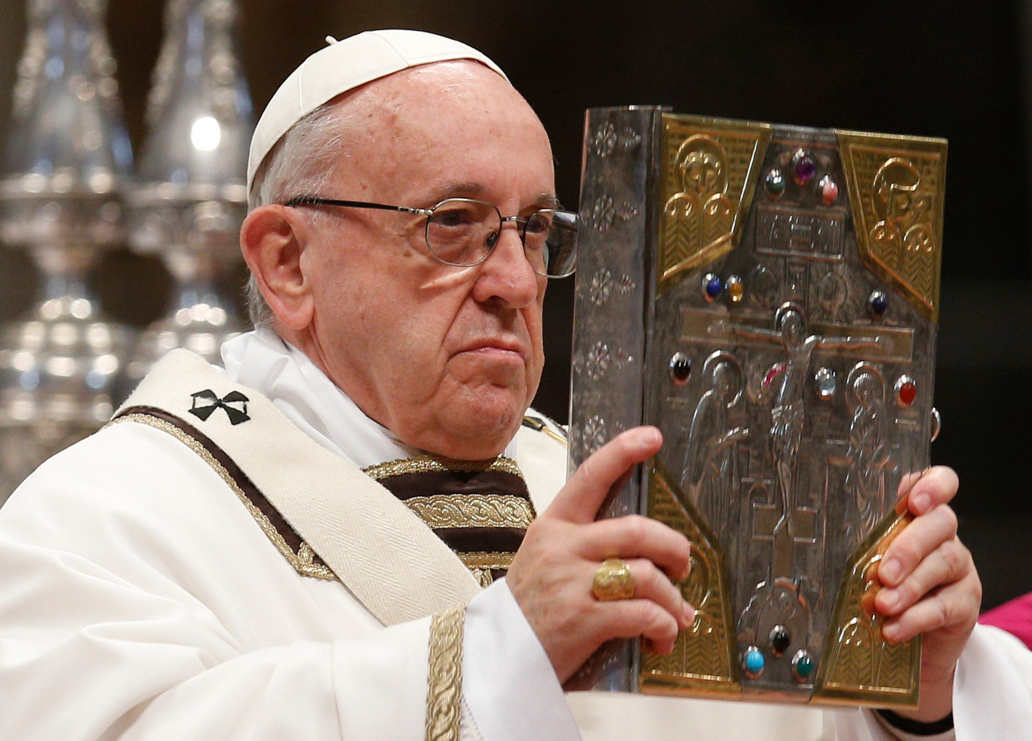 Pope Francis holds the Book of the Gospels as he celebrates Holy Thursday chrism Mass in St. Peter's Basilica at the Vatican March 29.